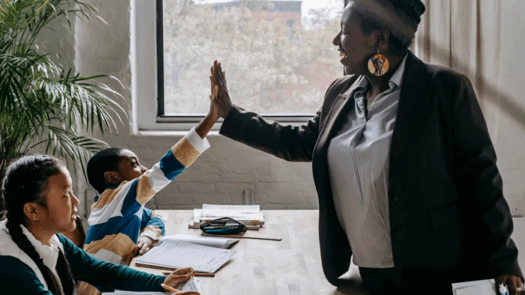 Teacher and student high five