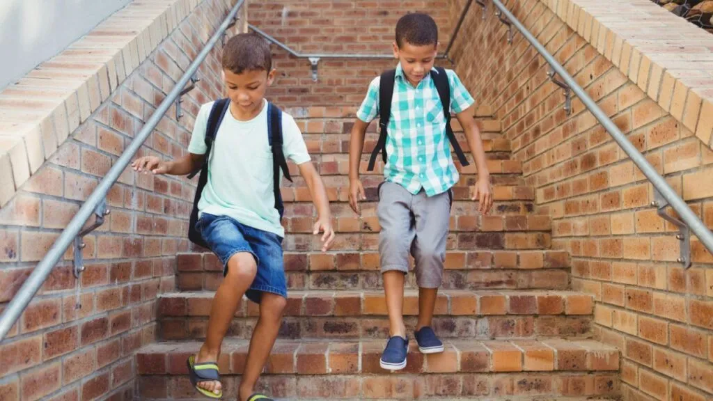 Two children going down the stairs