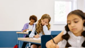 Students work independently in their notebooks at their desks