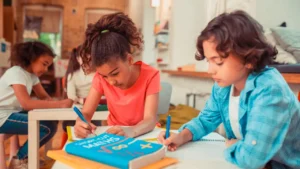 Two students writing in their notebooks