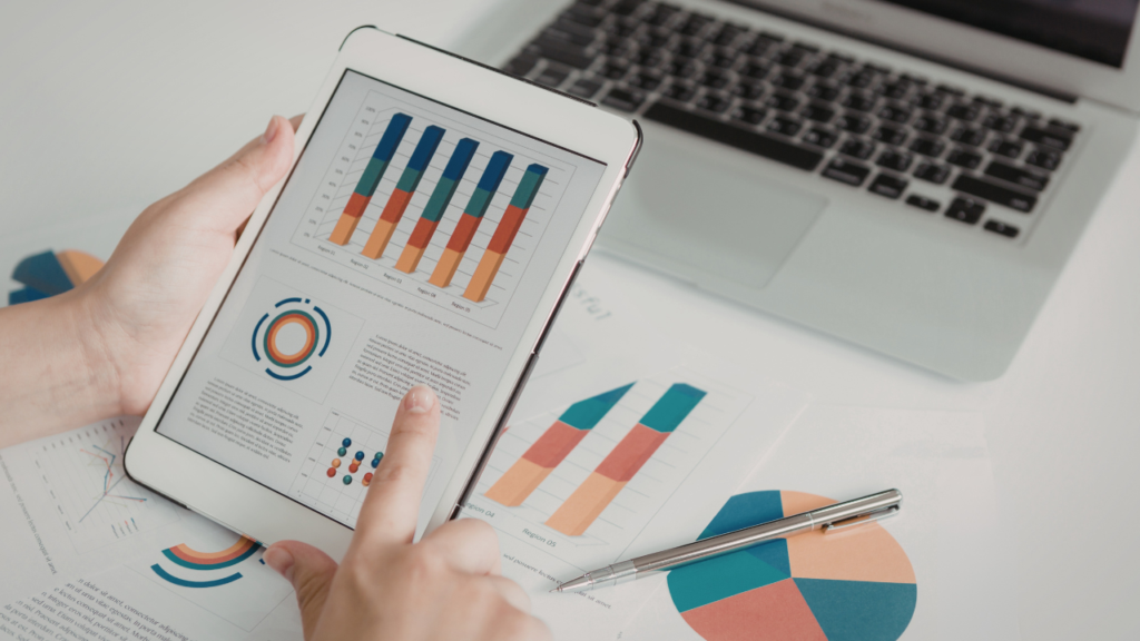 Person looks at an iPad displaying graphs and chart