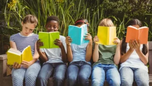 Group of students holding books of different colors
